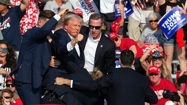 Donald Trump pumps his fist in defiance after the shooting. Picture: AFP