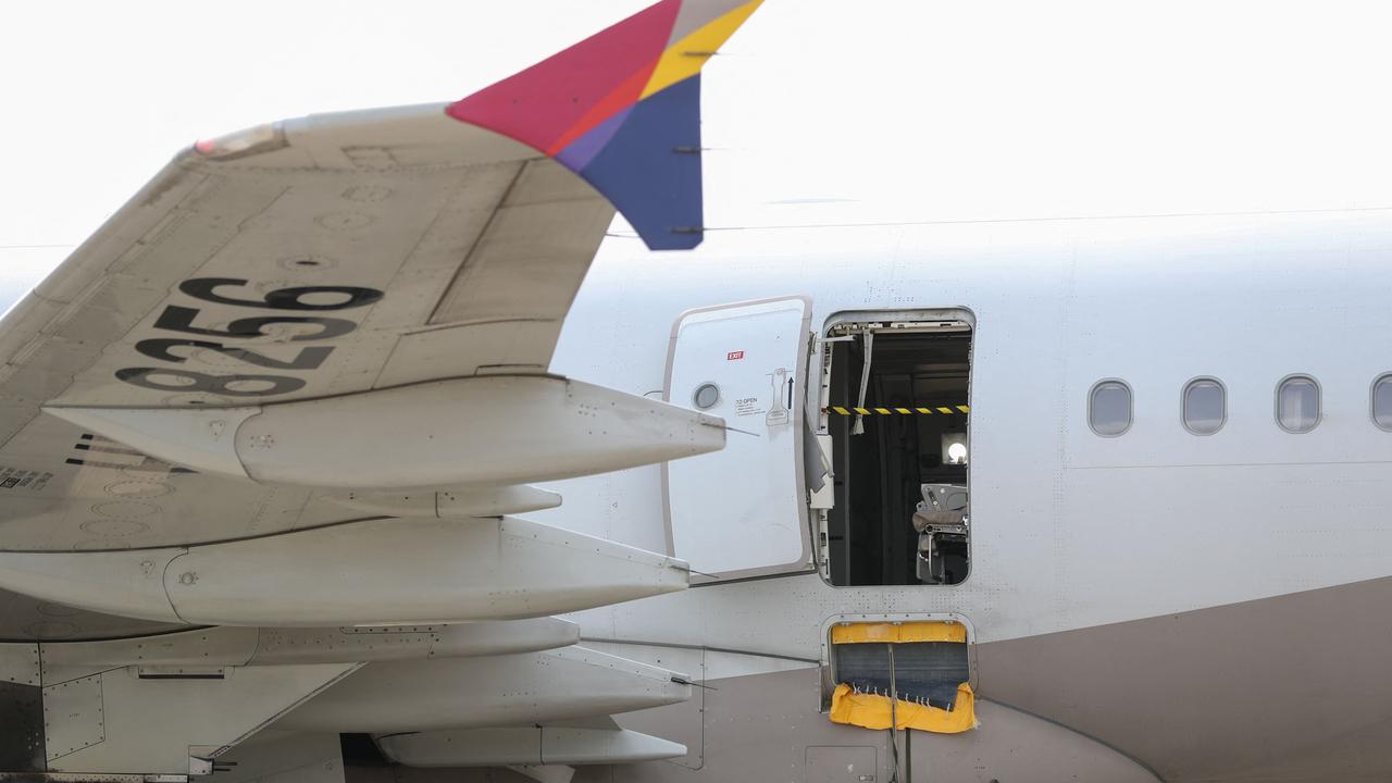 An opened door of an Asiana Airlines plane is seen at Daegu International Airport after it was manually opened by a passenger just 200 metres above the ground before landing. Picture: YONHAP / AFP