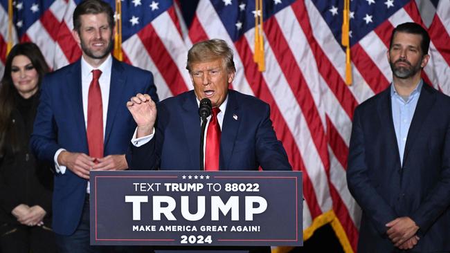 Former US President and Republican presidential hopeful Donald Trump, with sons Eric (2nd L) and Donald (R), speaks at a watch party during the 2024 Iowa Republican presidential caucuses in Des Moines, Iowa, on January 15, 2024. Picture: AFP