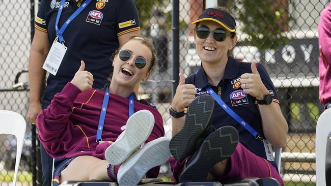 Reserves Gabby Collingwood and Sharni Webb watch on. Picture: lions.com.au