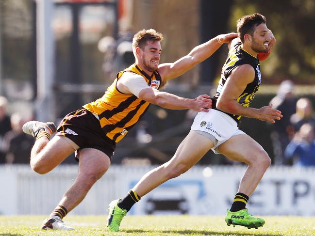 Mitch O'Donnell lays a tackle on former Tigers Sam Lloyd. Picture: Michael Klein