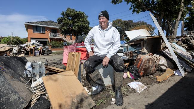 Eddie Hunter sits among the contents of his house in Oakland St, Maribrynong. Picture: David Geraghty