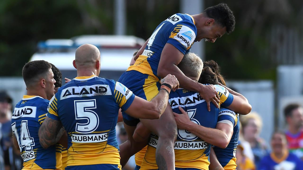 Waqa Blake leaps as he joins teammates as they celebrate a try in their elimination final win against the Newcastle Knights.