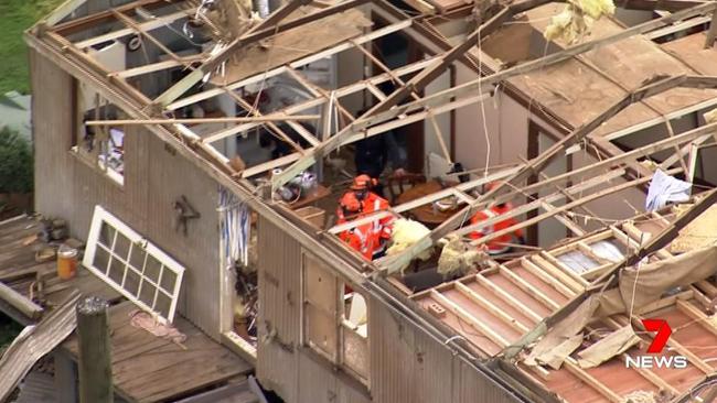 Emergency service workers work to stop any further damage. Picture: 7 News