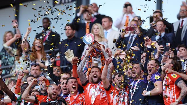 Sonny Bradley of Luton Town lifts the Sky Bet Championship Play Offs Final trophy. (Photo by Alex Pantling/Getty Images)