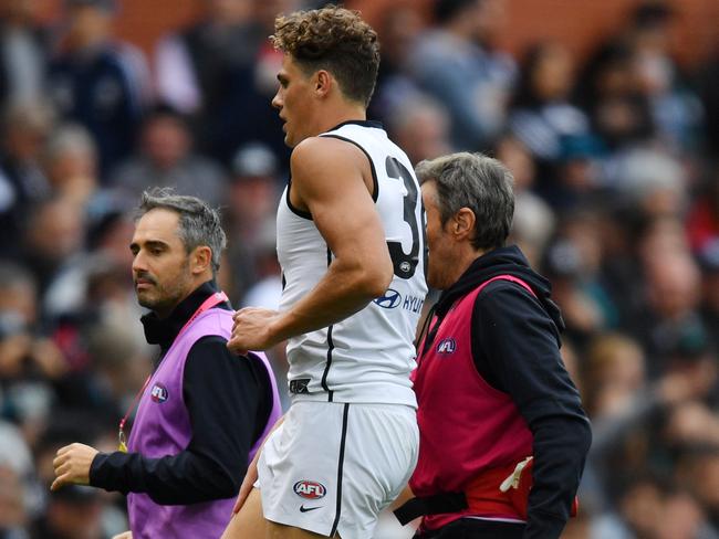 Charlie Curnow of the Blues comes off the field after an injury during the Round 2 AFL match between Port Adelaide Power and the Carlton Blues at the Adelaide Oval, Adelaide, Saturday, March 30, 2019. (AAP Image/David Mariuz) NO ARCHIVING, EDITORIAL USE ONLY