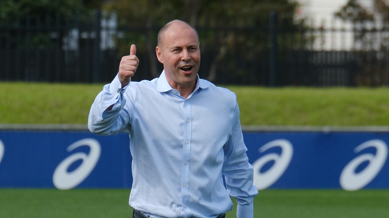 Treasurer Josh Frydenberg kicks a footy after giving a media conference at Whitten Oval. Picture: NCA NewsWire / Luis Enrique Ascui