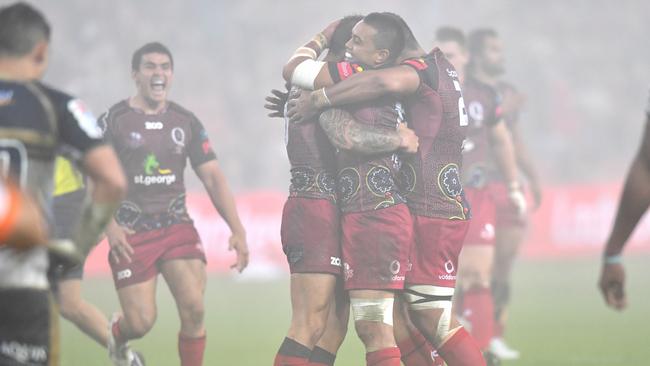 Reds players celebrate after Quade Cooper kicked the winning penalty goal. Picture: AAP.