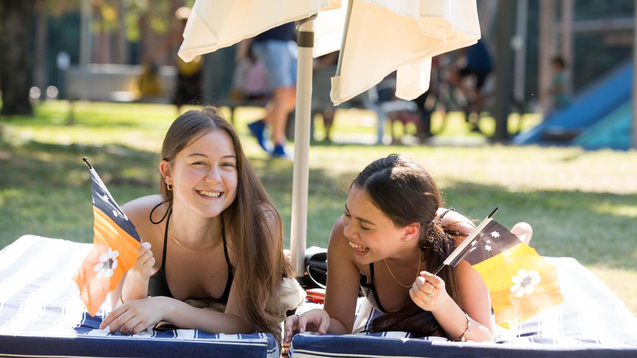 Abbie Wheeler and Kimberlee Sabino soak up the sun at the Darwin Waterfront. Picture: Glenn Campbell