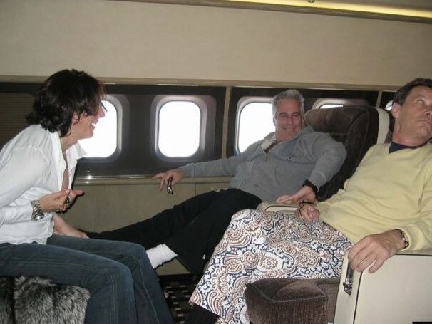 Ghislaine Maxwell is photographed massaging Jeffrey Epstein's feet in front of another man. Picture: Southern District Court of New York/AFP