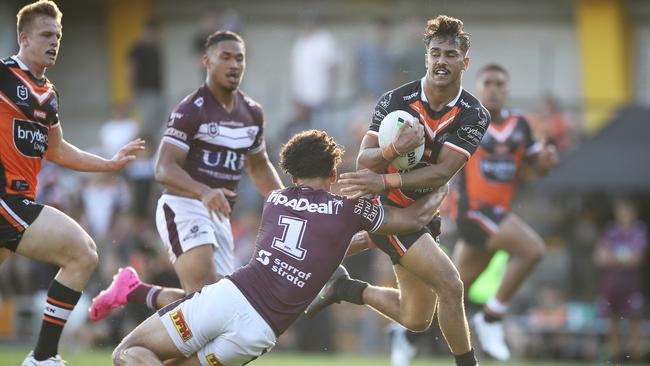 SYDNEY, AUSTRALIA – FEBRUARY 28: Daine Laurie of the Tigers is tackled after making a break during the NRL Trial Match between the Wests Tigers and the Manly Sea Eagles at Leichhardt Oval on February 28, 2021 in Sydney, Australia. (Photo by Mark Kolbe/Getty Images)