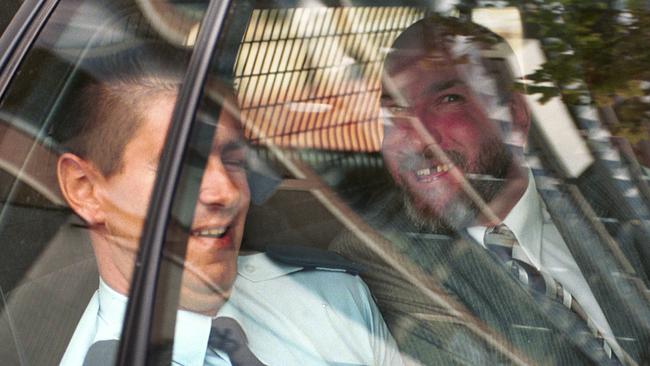 Fyfe tries to kiss a prison guard on the cheek while being driven from court to Yatala Labor Prison, 2000.