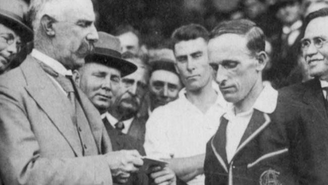 Clarrie Grimmett receives a cheque after his Test debut where he took 11/82 at the SCG.