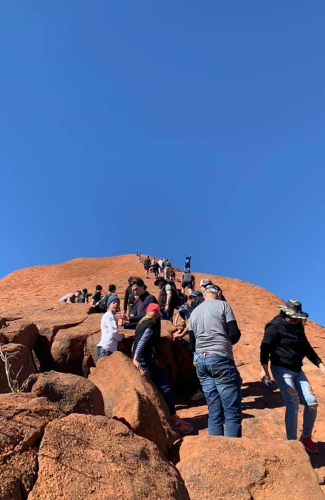 The queue stretching up Uluru.