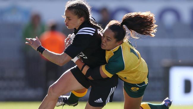 New Zealand Black's Selica Winiata is tackled by Australia's Shontelle Stowers.