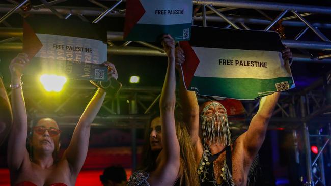 Participants hold up Free Palestine posters as they take part in the Sydney Gay &amp; Lesbian Mardi Gras Parade.