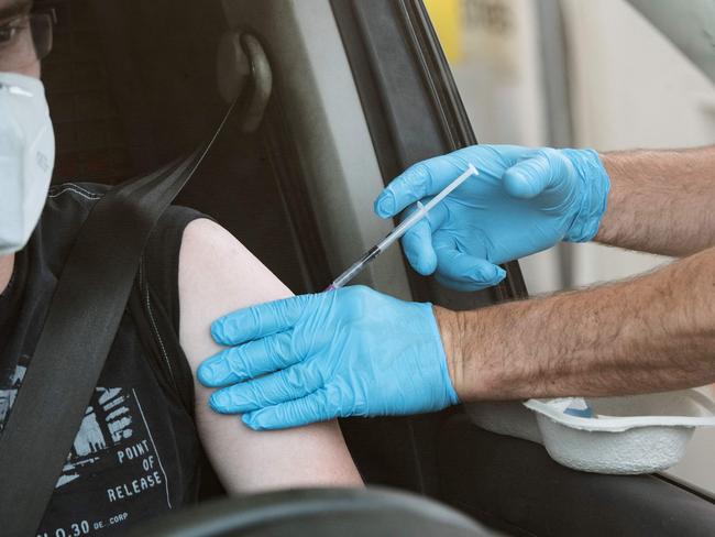 A man is vaccinated in his car at Berlin's first drive thru vaccination centre against the COVID-19 coronavirus, on July 17, 2021. Picture: AFP