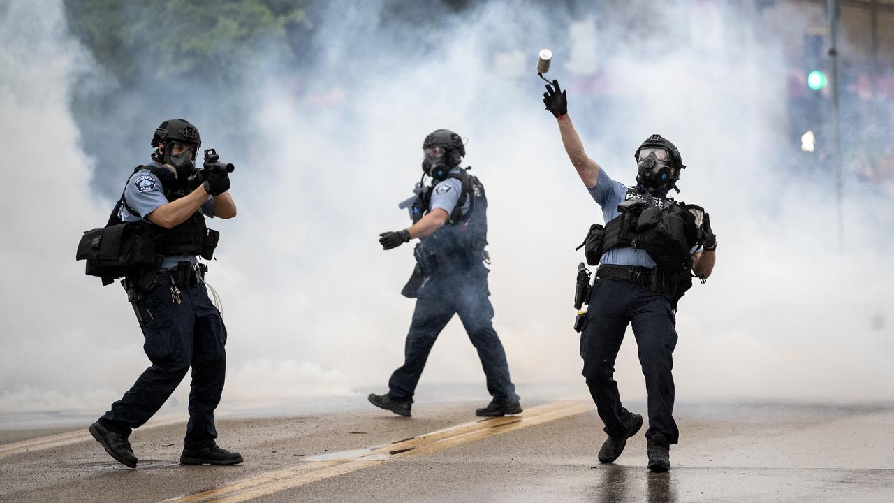 Officers launch tear gas canisters at protesters. Picture: Richard Tsong-Taatarii/Star Tribune via AP