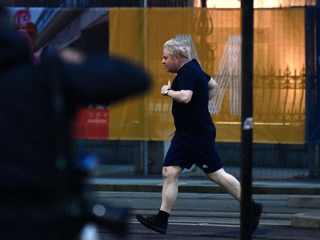 TOPSHOT - Britain's Prime Minister Boris Johnson goes for a run before the second day of the annual Conservative Party Conference being held at the Manchester Central convention centre in Manchester, north-west England, on October 4, 2021. (Photo by Ben STANSALL / AFP)