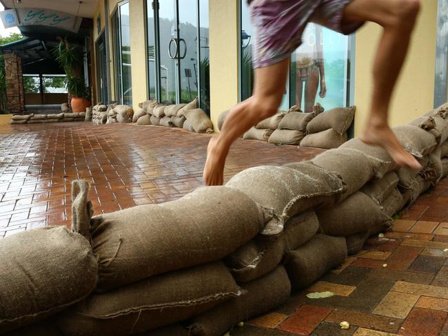 Sandbagging in the main street of Airlie Beach in preparation for cyclone Debbie. Picture: Liam Kidston.