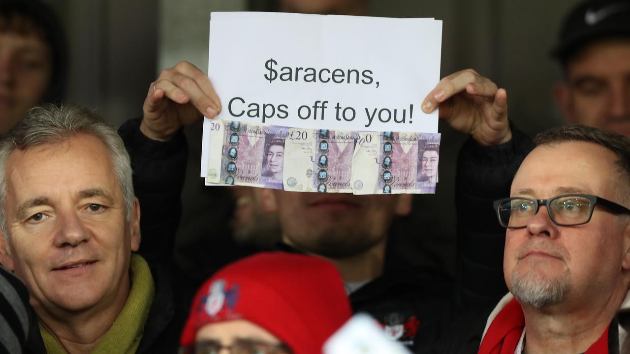 Gloucester supporters show a sign directed at Saracens and the salary cap scandal.