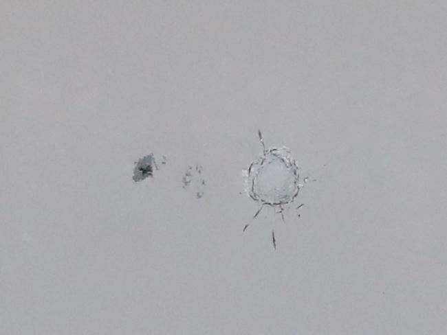 An apparent bullet hole in a window. Picture: David Crosling