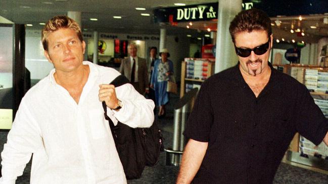 George Michael and Kenny Goss at London's Heathrow Airport in 1998.