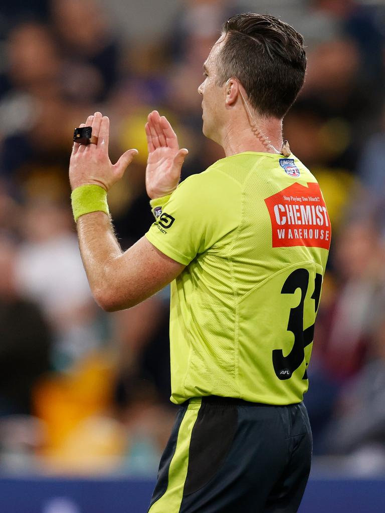 Umpire Jacob Mollison calls for a review. Picture: Michael Willson/AFL Photos via Getty Images