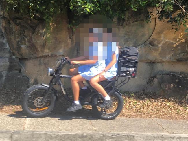 Secondary schools students, without helmets on an e-bike on Oliver St, Freshwater. Picture: Jim O'Rourke