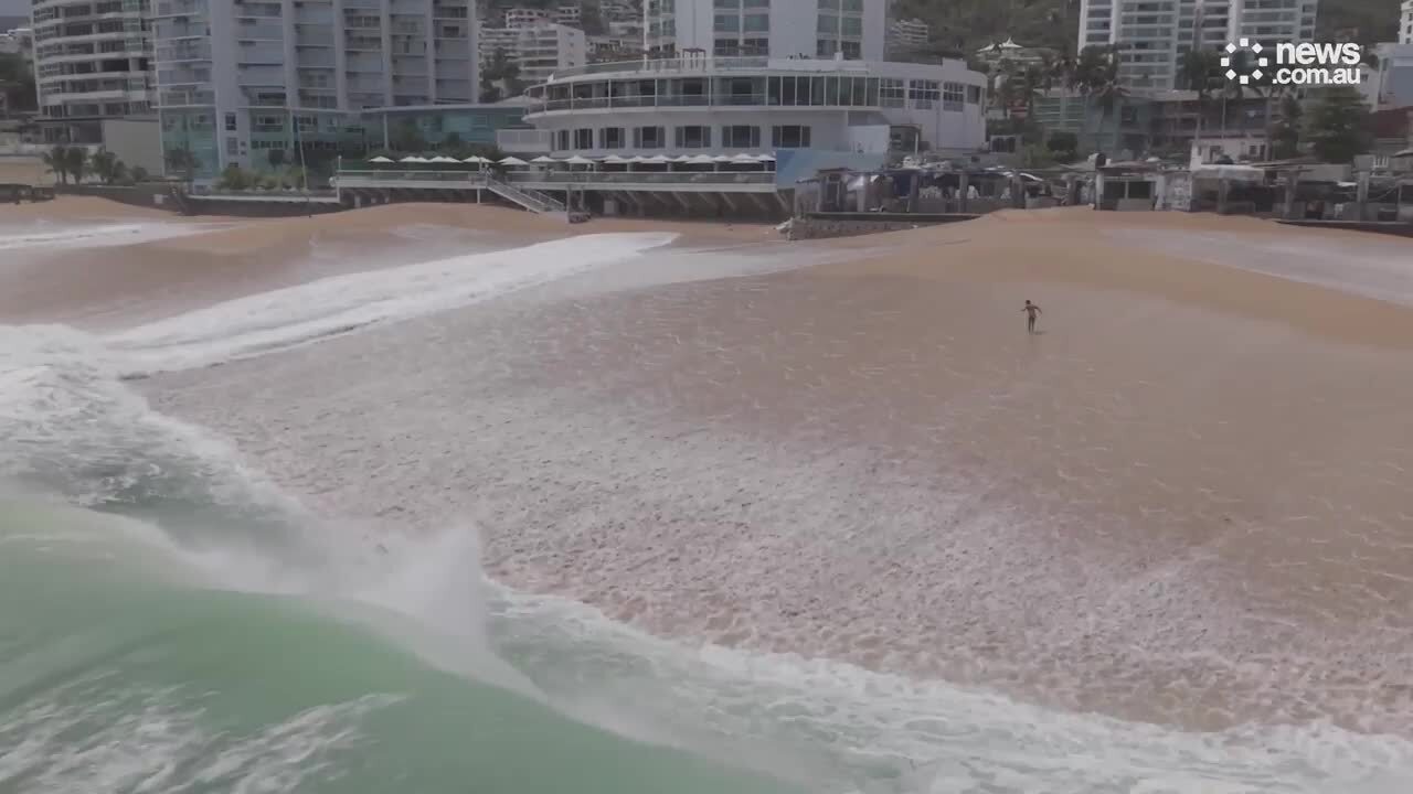 Moment giant wave swallows up swimmers