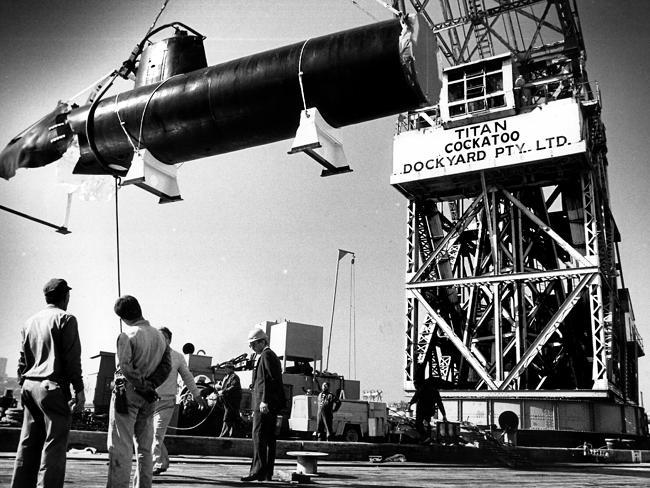 1987: The Cockatoo Island Dockyard crane Titan lifts a restored section of a bombed Japanese WWII  midget submarine it lifted from the harbour sea bed.