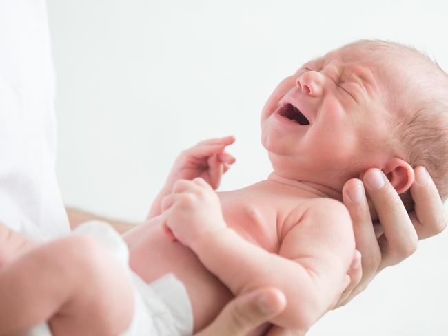 Portrait of a screaming newborn hold at hands, family, healthy birth concept photo, close up  - Picture istock