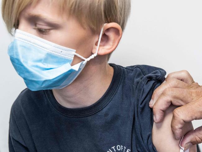 Leopold Nytoft Bergman, 10 years old, receives a vaccination against the novel coronavirus on November 28, 2021 in Amagar, Denmark. - Children between 5 - 11 years can now be vaccinated in Denmark. The vaccinations on November 28, 2021 are reserved for the oldest children in the group. Therefore, so far only children aged 10 and 11 have been invited to a vaccine via their parents. (Photo by Olafur STEINAR GESTSSON / Ritzau Scanpix / AFP) / Denmark OUT