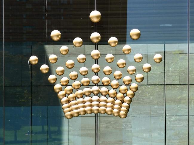 A cleaner works outside an entrance to Crown Casino in Melbourne on October 26, 2021. (Photo by William WEST / AFP)