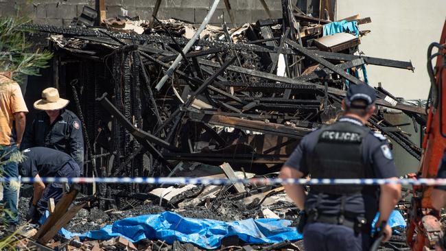 Police search the ruins of the fire-ravaged Browns Plains townhouse where two bodies where found. Picture: Brad Fleet