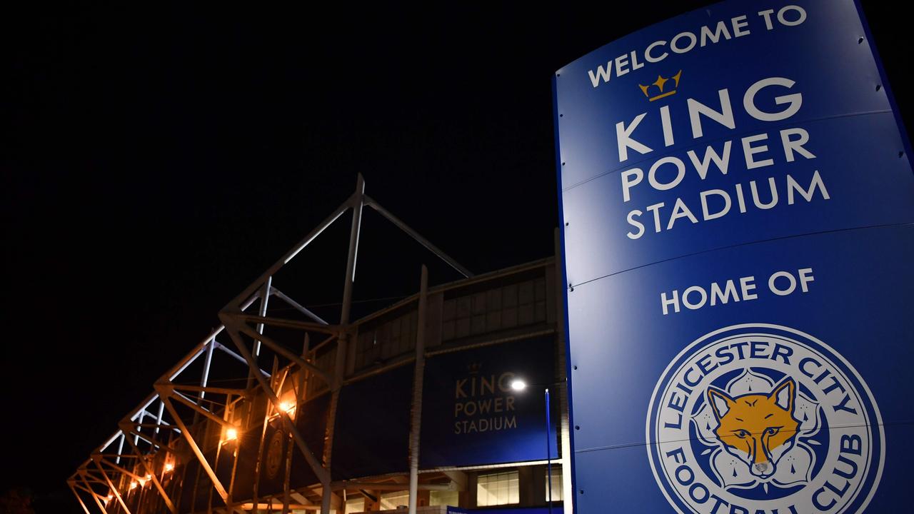 Media and members of the public are seen at a police cordon outside Leicester City Football Club's King Power Stadium in Leicester