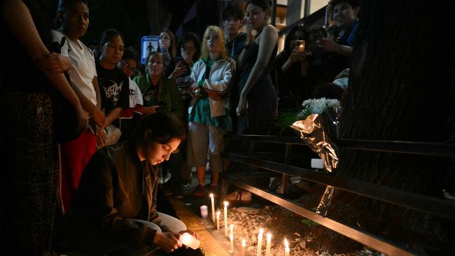 Fans light a candle next to the hotel where Liam Payne died in Buenos Aires. Picture: AFP