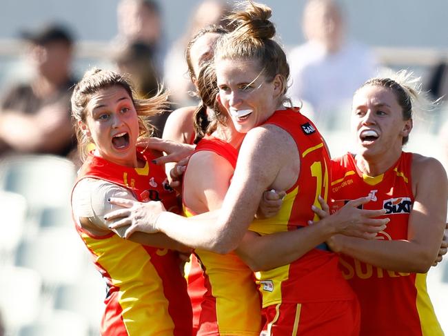 MELBOURNE, AUSTRALIA - OCTOBER 08: Tara Bohanna of the Suns celebrates a point after the siren with teammates to win the match during the 2023 AFLW Round 06 match between the Richmond Tigers and the Gold Coast SUNS at IKON Park on October 08, 2023 in Melbourne, Australia. (Photo by Michael Willson/AFL Photos via Getty Images)