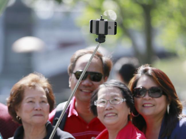 A group of tourist taking a photo with a Selfie stick that was banned in South Korea (not available in the North yet). Picture: Valeriu campan