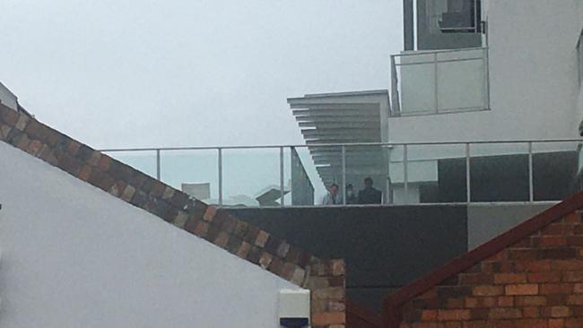 Police officers at the pool area of The Oaks Ipswich Aspire Suites on Wednesday morning. Photo: Ross Irby