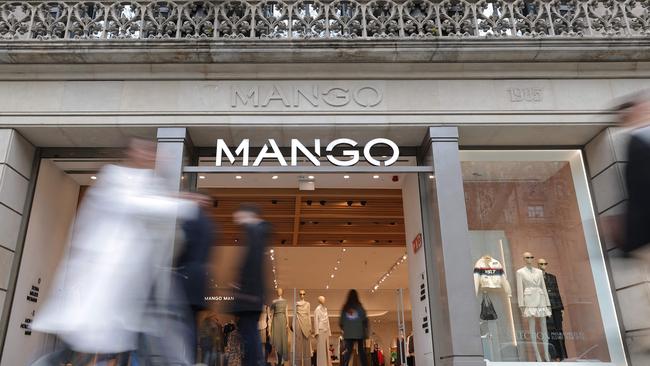 Pedestrians walk by the entrance of a Mango shop on Passeig de Gracia street in Barcelona. Picture: Lluis Gene/AFP