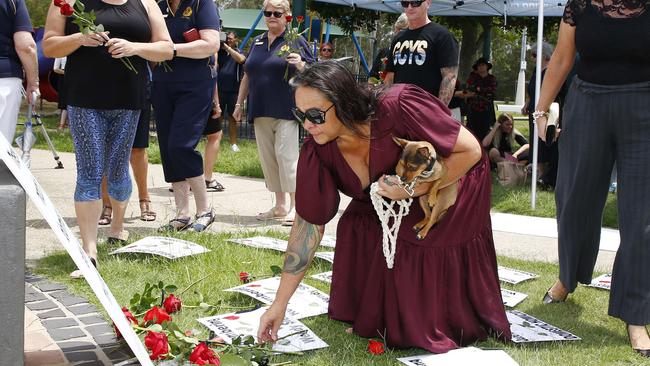 A member of the public lays a rose at the Red Rose Foundation rally to remember Wendy Sleeman. Picture: Tertius Pickard