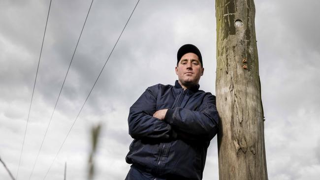 Keeping watch: Ecklin South dairy farmer Simon Craven says Powercor is taking the cheap option of staking “way too many” power poles, rather than replacing them.