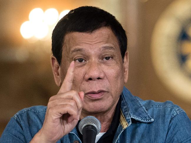 Philippine's President Rodrigo Duterte gestures as he answers a question during a press conference at the Malacanang palace in Manila on January 30, 2017. Philippine's President Rodrigo Duterte on January 30, 2017 extended his deadly drug war until the last day of his term in 2022, but conceded the police force acting as his frontline troops was 