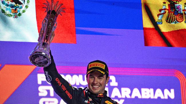 Red Bull Racing's Mexican driver Sergio Perez celebrates with the trophy on the podium after winning the Saudi Arabia Formula One Grand Prix at the Jeddah Corniche Circuit. Picture: AFP