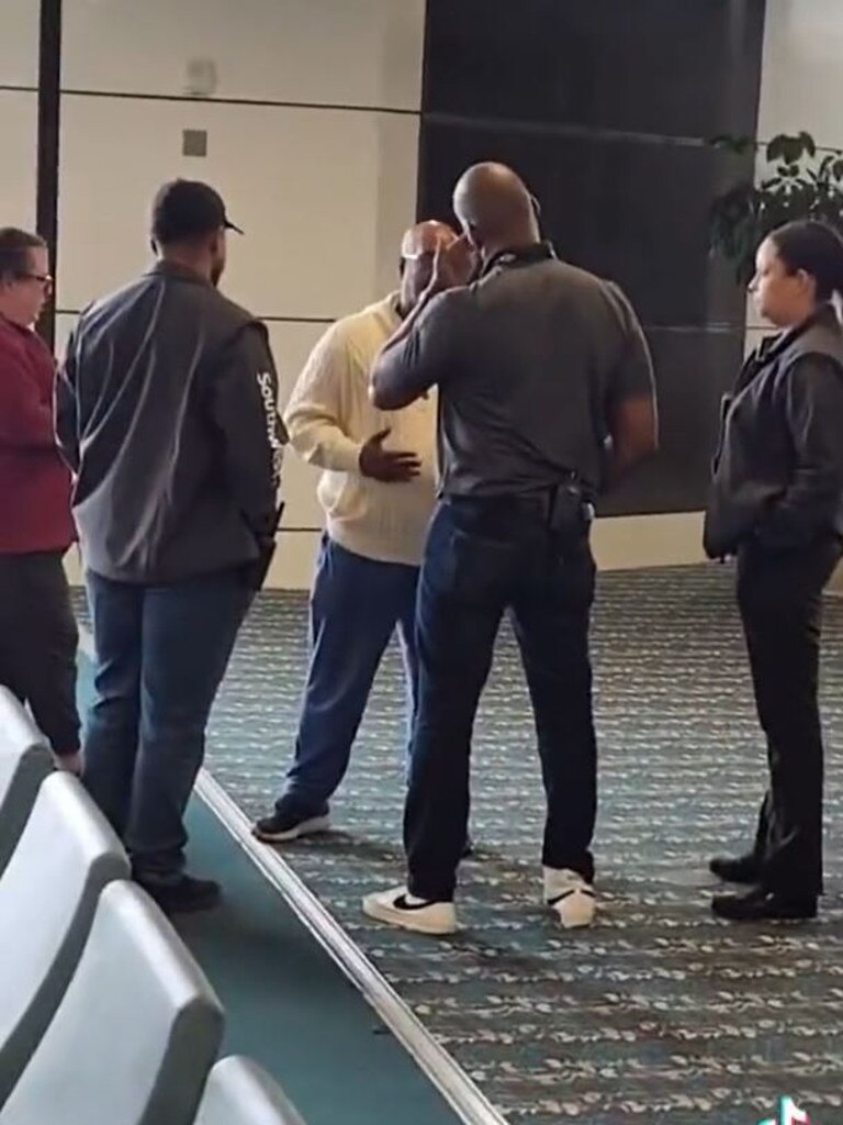The man is spoken to by security. Picture: TikTok / @mjgrabowski