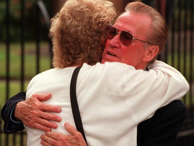 Bob Burton, father of Jason who was stabbed to death by Emad Sleiman outside General Bourke Hotel in Parramatta in 1997, is comforted by friend outside Supreme Court in Sydney after Sleiman was sentenced to minimum of 16 years jail.