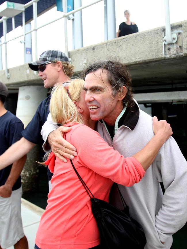 Passengers from the pearling lugger, Falla, safely arrive back in Cairns aboard Ocean Freedom after their boat sunk in 2009. Doug Meyer is pictured hugging a passenger at the Marlin Marina at the time.