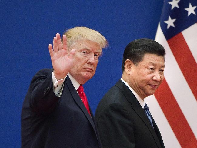 (FILES) In this file photo US President Donald Trump (L) and China's President Xi Jinping leave a business leaders event at the Great Hall of the People in Beijing on November 9, 2017. - Donald Trump pleaded with China's leader Xi Jinping for help to win re-election in 2020, the US president's former aide John Bolton writes in an explosive new book, according to excerpts published June 17. (Photo by Nicolas ASFOURI / AFP)