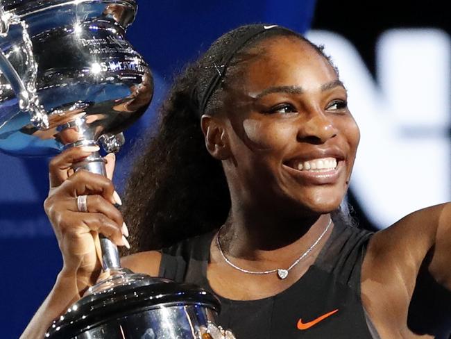 FILE - In this Saturday, Jan. 28, 2017, file photo, United States' Serena Williams holds her trophy after defeating her sister Venus during the women's singles final at the Australian Open tennis championships in Melbourne, Australia. Unbeknownst to fans and foes, Serena Williams was two months pregnant when she won the 2017 Australian Open. Williams is expected to have a strong 2018. (AP Photo/Dita Alangkara, File)